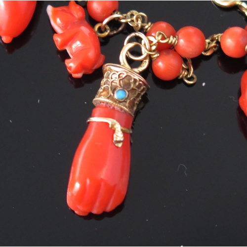 271 - An Antique Coral Charm Bracelet with precious yellow metal mounts including a skull, turquoise mount... 