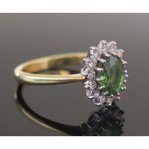 286 - A Green Tourmaline and Diamond Cluster Ring, c. 7.5x6mm principal stone with c. 1.8mm brilliant roun... 