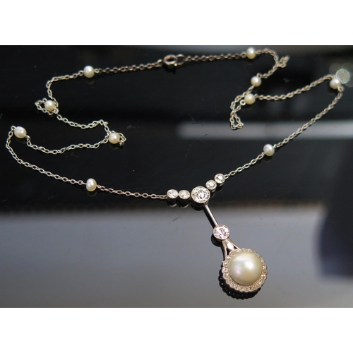 287 - A Pearl or Cultured Pearl and Diamond Pendant on an integrated pearl mounted chain in a precious whi... 