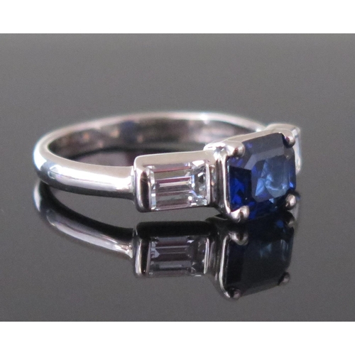 289 - An 18ct White Gold, Sapphire and Diamond Three Stone Ring, c. 7.1x6.6mm principal stone flanked by 4... 