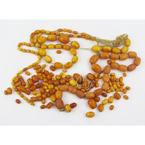 134 - A Quantity of Amber and Faux Amber Beads, largest 21.4x16.1mm, 112.88g