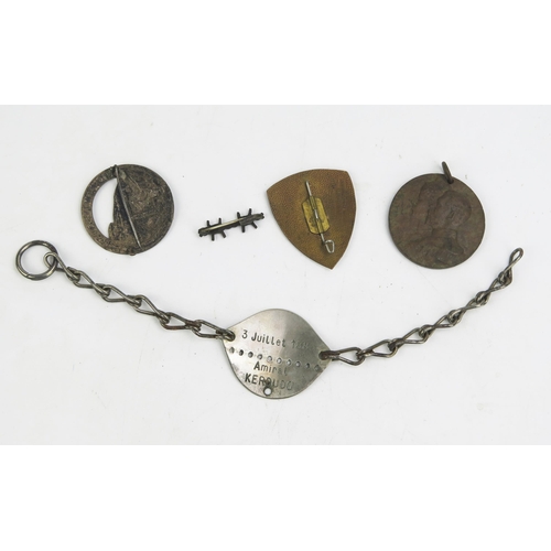 1349 - A French lapel badge commemorating the battle for Verdun, an identity tag, a peace medal and a ename... 