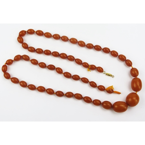 135 - A Pressed Amber Graduated Bead Necklace, largest 27.7x24.5mm, second largest 28.3x21.5mm, 39