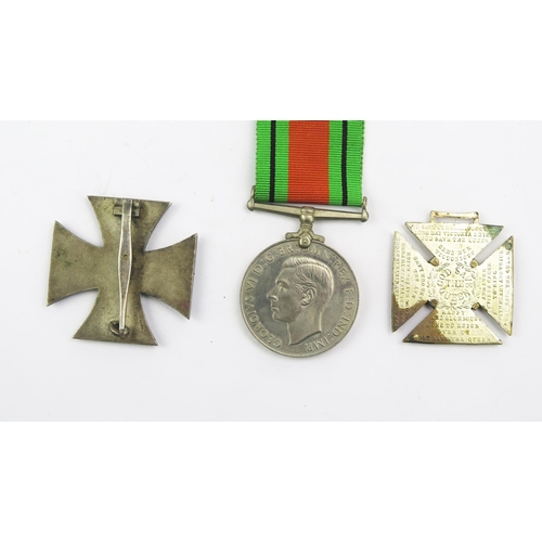 1350B - A Third Reich period Iron Cross 1st class, a Defence Medal and a Victoria commemorative cross.