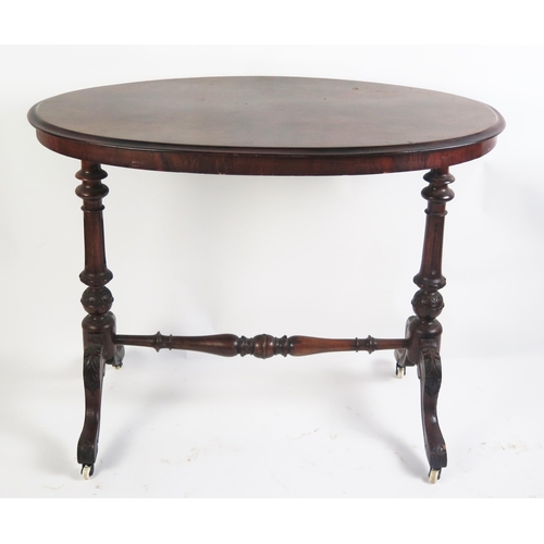 1706 - A Victorian occasional table the oval quarter veneered top raised on single column trestle end suppo... 