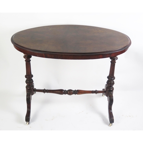 1706 - A Victorian occasional table the oval quarter veneered top raised on single column trestle end suppo... 