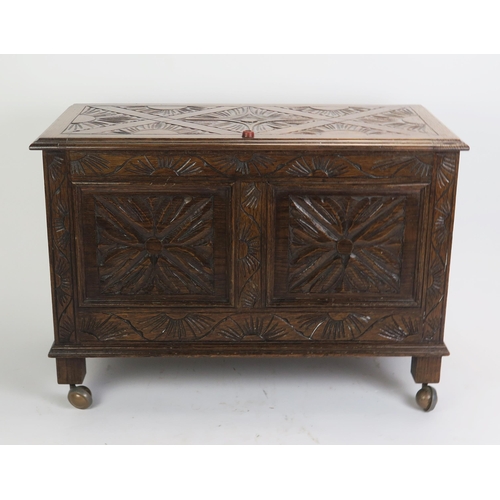 1709 - A reproduction carved oak coffer in the 17th century taste, the carved hinged lid with moulded edge ... 