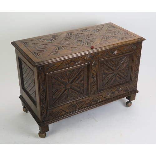 1709 - A reproduction carved oak coffer in the 17th century taste, the carved hinged lid with moulded edge ... 