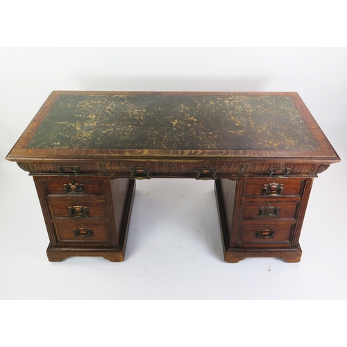 1711 - A late Victorian oak twin pedestal desk, the rectangular top with inset leather writing surface, wit... 