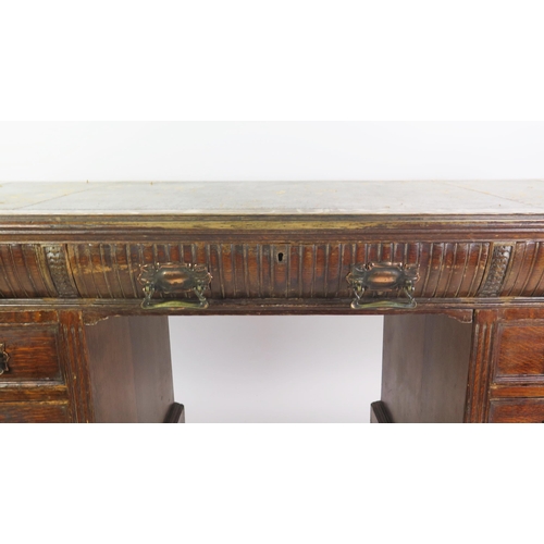 1711 - A late Victorian oak twin pedestal desk, the rectangular top with inset leather writing surface, wit... 