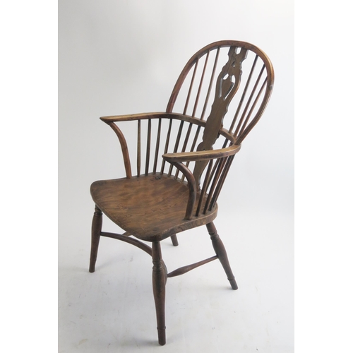 1713 - A late 18th century elm Windsor style elbow chair, the arch back with central shaped splat having sh... 