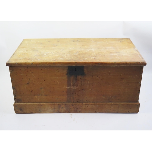 1714 - A 19th century stripped pine blanket box, with rectangular hinged lid, plain sides on a plinth base,... 