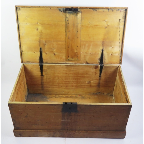 1714 - A 19th century stripped pine blanket box, with rectangular hinged lid, plain sides on a plinth base,... 