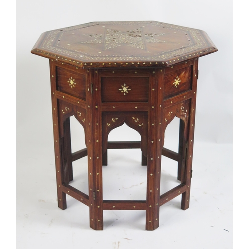 1715 - An Indian hard wood, ebony and bone inlaid tiffin table of octagonal outline, the top with inlaid st... 