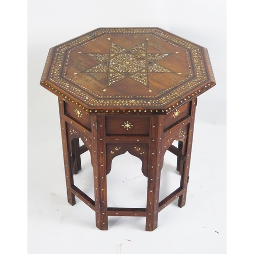 1715 - An Indian hard wood, ebony and bone inlaid tiffin table of octagonal outline, the top with inlaid st... 