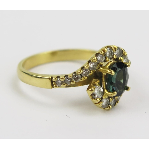 337 - An 18ct Gold, Green Sapphire and Diamond Crossover Ring size Q, stamped 750, 5.58g