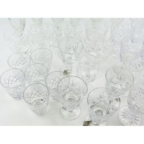 1242 - A collection of part suites of cut glass drinking vessels, including champagne flutes, wine glasses,... 