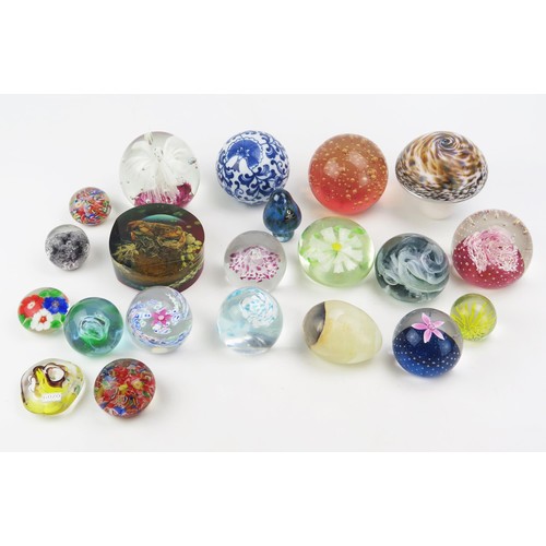 1639A - A collection of assorted glass paperweights of various sizes, together with a resin rock pool paperw... 