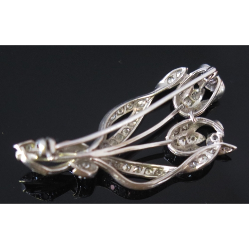 13 - A Diamond Tulip Spray Brooch in a precious white metal setting, c. 3.54mm largest old cuts, 43.8mm, ... 