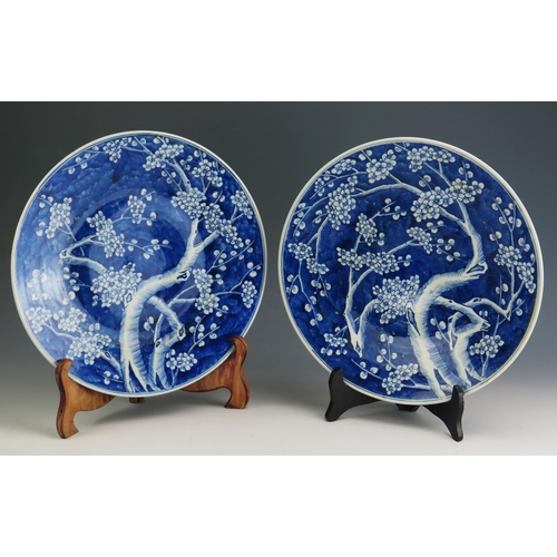 144 - A pair of Qing Chinese blue and white chargers, with all over prunus decoration, 37cm diameter.