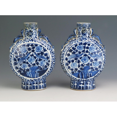 148 - A pair of Chinese blue and white porcelain moon flasks, of traditional design with dragon handles, a... 