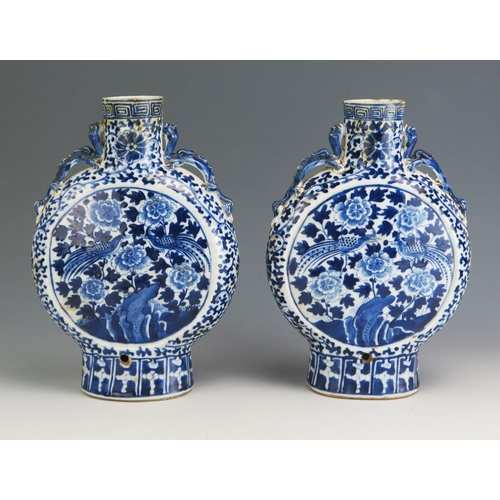 148 - A pair of Chinese blue and white porcelain moon flasks, of traditional design with dragon handles, a... 