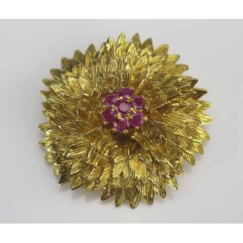 15 - An 18K Gold and Ruby Circular Floral Brooch, 38.45mm largest diameter, stamped ITALY 18K, 19.77G