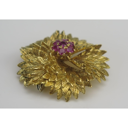 15 - An 18K Gold and Ruby Circular Floral Brooch, 38.45mm largest diameter, stamped ITALY 18K, 19.77G