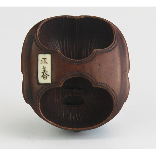 155 - A Japanese carved boxwood netsuke of a female noh theatre mask, signed possibly Gyokushu, to the ivo... 