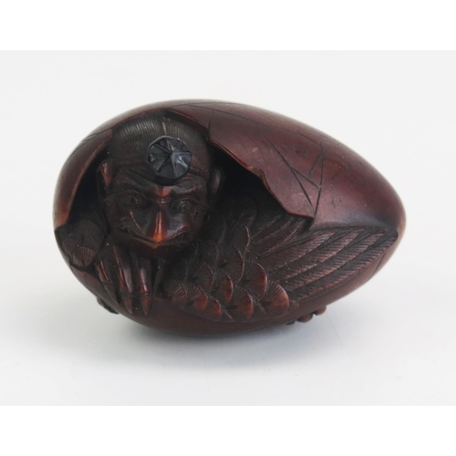 159 - A Japanese carved hardwood netsuke depicting Tengu hatching from an egg, unsigned, 4cm long, Meiji p... 