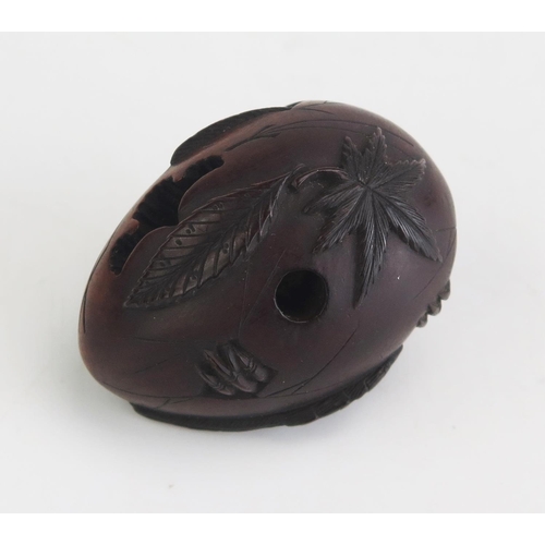 159 - A Japanese carved hardwood netsuke depicting Tengu hatching from an egg, unsigned, 4cm long, Meiji p... 