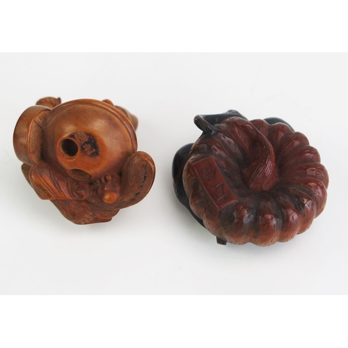 162 - A Japanese carved boxwood netsuke depicting a gourd, signed, 4cm diameter, and another netsuke of a ... 