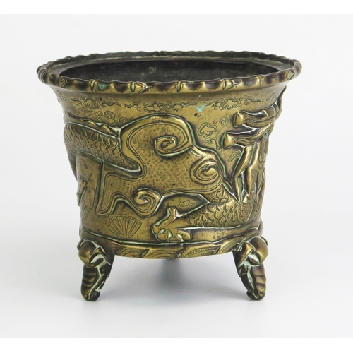 164 - An Antique Chinese cast bronze pot of cylindrical tapering outline, with simulated bamboo rim, the s... 