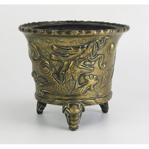 164 - An Antique Chinese cast bronze pot of cylindrical tapering outline, with simulated bamboo rim, the s... 