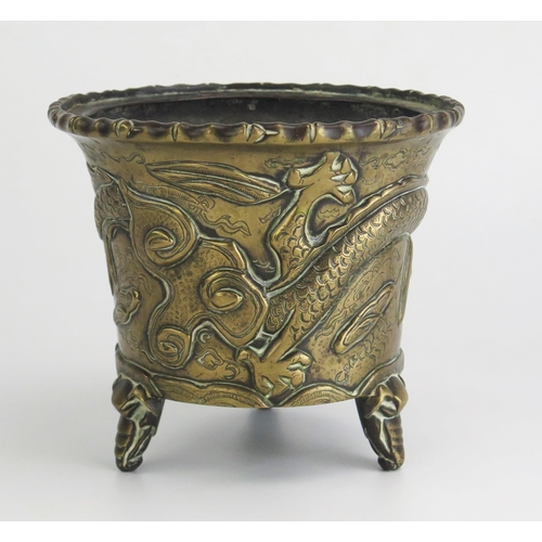 164 - An Antique Chinese cast bronze pot of cylindrical tapering outline, with simulated bamboo rim, the s... 