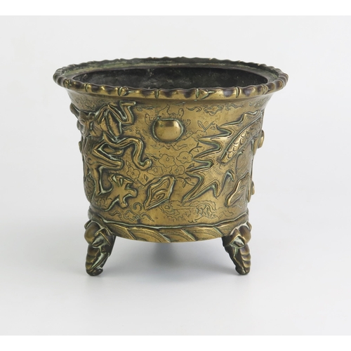 164 - An Antique Chinese cast bronze pot of cylindrical tapering outline, with simulated bamboo rim, the s... 