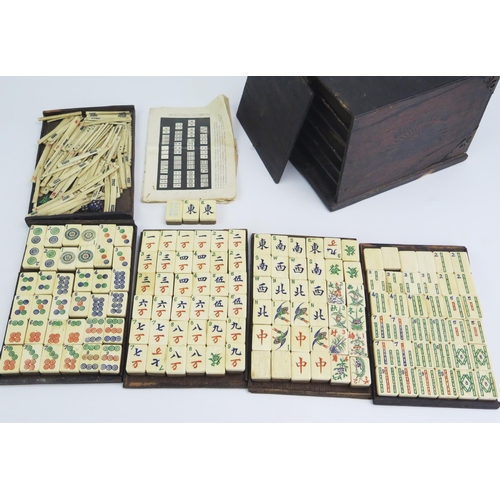 165 - An early 20th century Mah Jong set with bone and bamboo backed tiles, gaming counters, instructions,... 