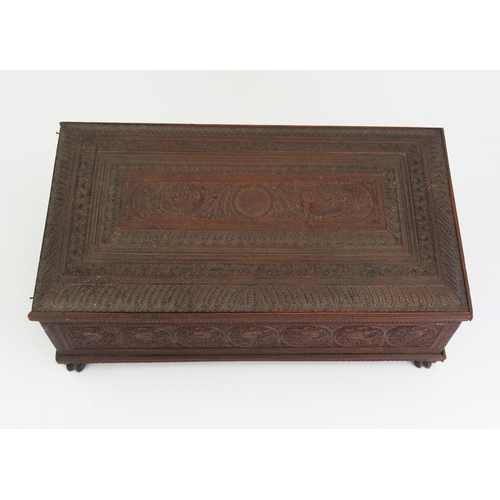 166 - A 19th Century Indian carved sandal wood table top casket, of rectangular outline, with lift off lid... 