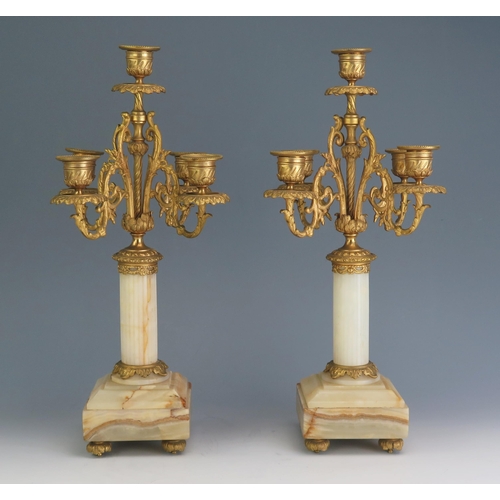 169 - A pair of 19th century alabaster, marble and ormolu five light candelabra with urn-shaped sconces on... 