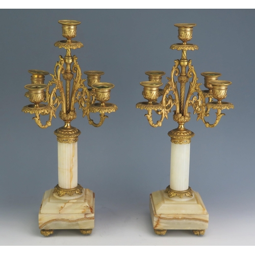 169 - A pair of 19th century alabaster, marble and ormolu five light candelabra with urn-shaped sconces on... 