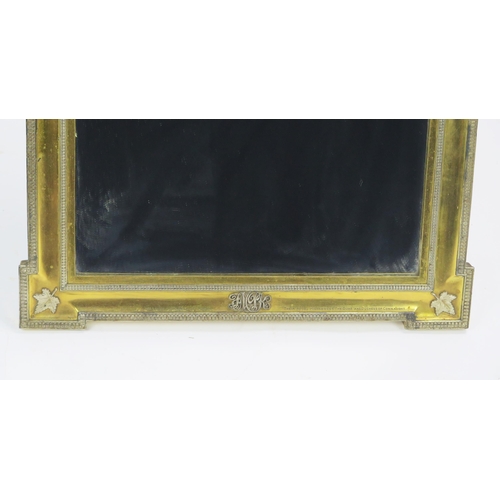 170 - A Royal Presentation gilt metal and metal mounted easel back mirror of arched outline, the pediment ... 