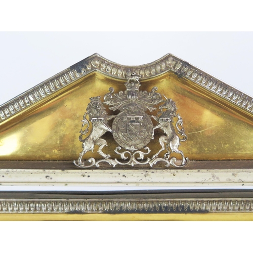 170 - A Royal Presentation gilt metal and metal mounted easel back mirror of arched outline, the pediment ... 