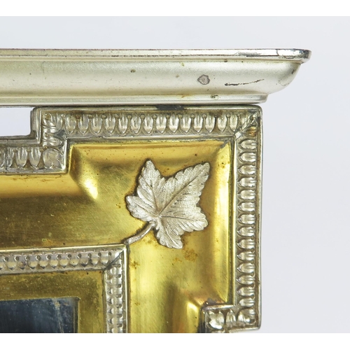 170 - A Royal Presentation gilt metal and metal mounted easel back mirror of arched outline, the pediment ... 