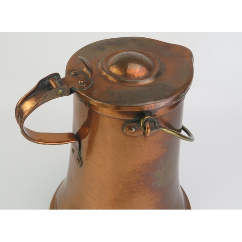 179 - A 19th century copper water jug and cover, of cylindrical tapering form, with loop carrying handle h... 