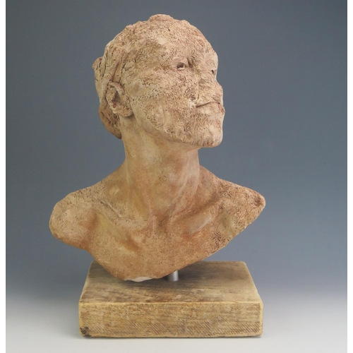 185 - A modernist terracotta bust, with partially defaced head, unsigned, mounted on a rectangular plinth ... 