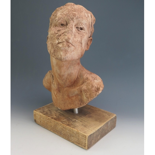 185 - A modernist terracotta bust, with partially defaced head, unsigned, mounted on a rectangular plinth ... 