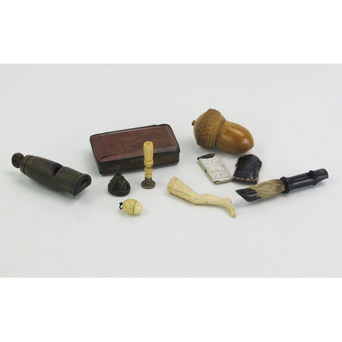 192 - A small amount of collectables including a treen needle case in the form of an acorn, a bone seal in... 