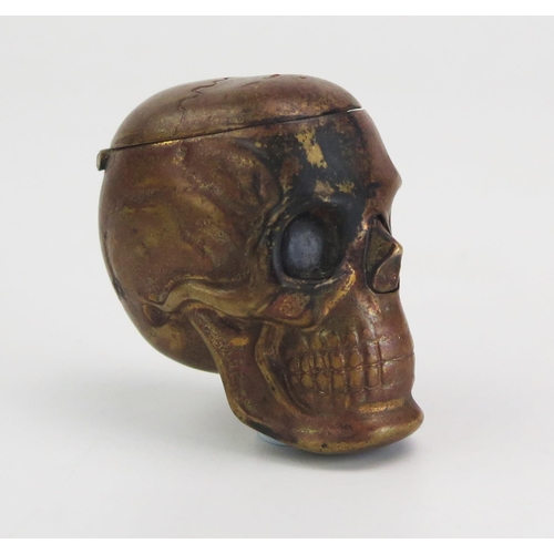 195 - A novelty pressed metal vesta case in the form of a human skull, 4.25cm high.