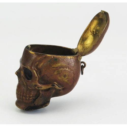 195 - A novelty pressed metal vesta case in the form of a human skull, 4.25cm high.