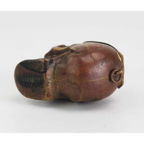 195 - A novelty pressed metal vesta case in the form of a human skull, 4.25cm high.